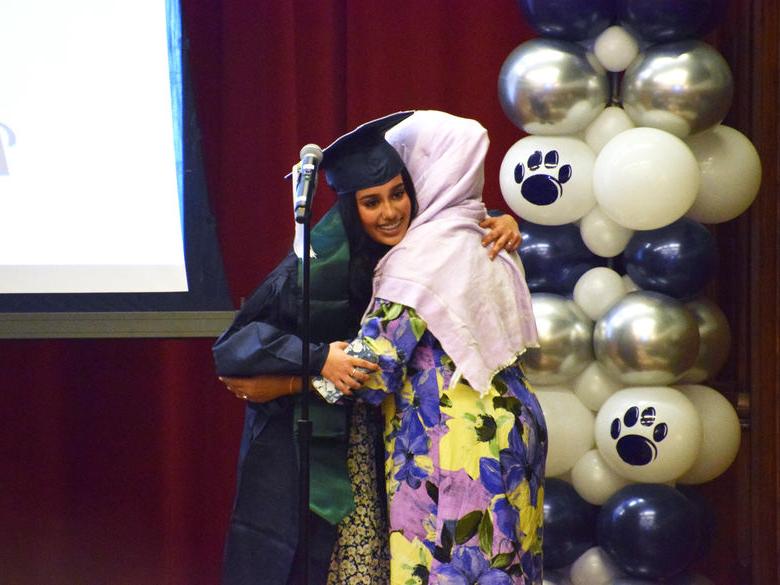 Two students hugging at cultural graduation 